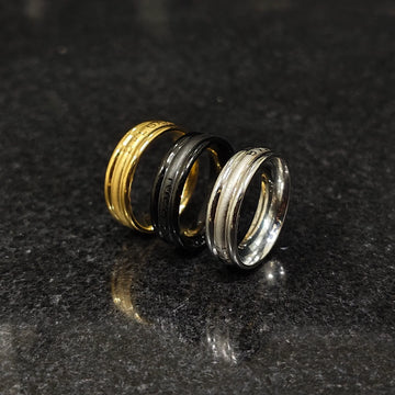 Set of 3 ferrum rings in pakistan by Lamha featuring gold, black, and silver tones on a dark surface