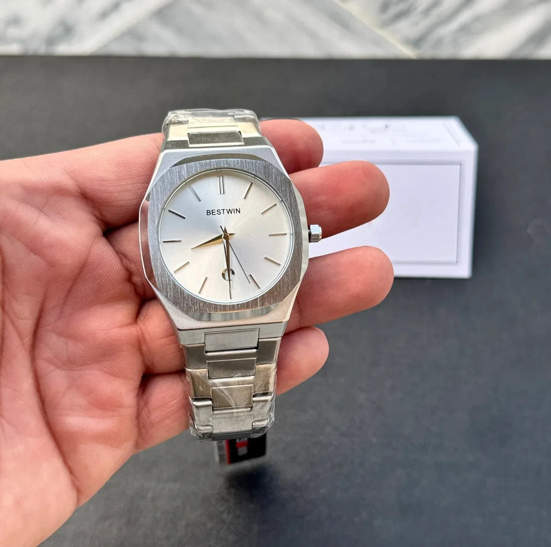Bestwin Date Just Watch in Silver White with metal strap and minimalist dial held in white glove