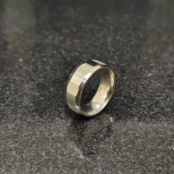 Lamha diamond ring for men in silver color with a polished faceted design on a dark surface