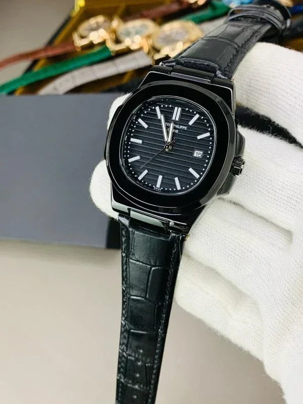 Patek philippe Black strap watch with a black dial and silver hour markers held by a gloved hand