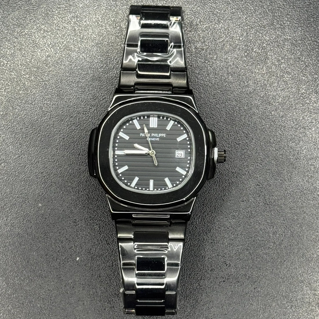 Patek Philippe In Black wristwatch with stainless steel band and black dial showing date and time