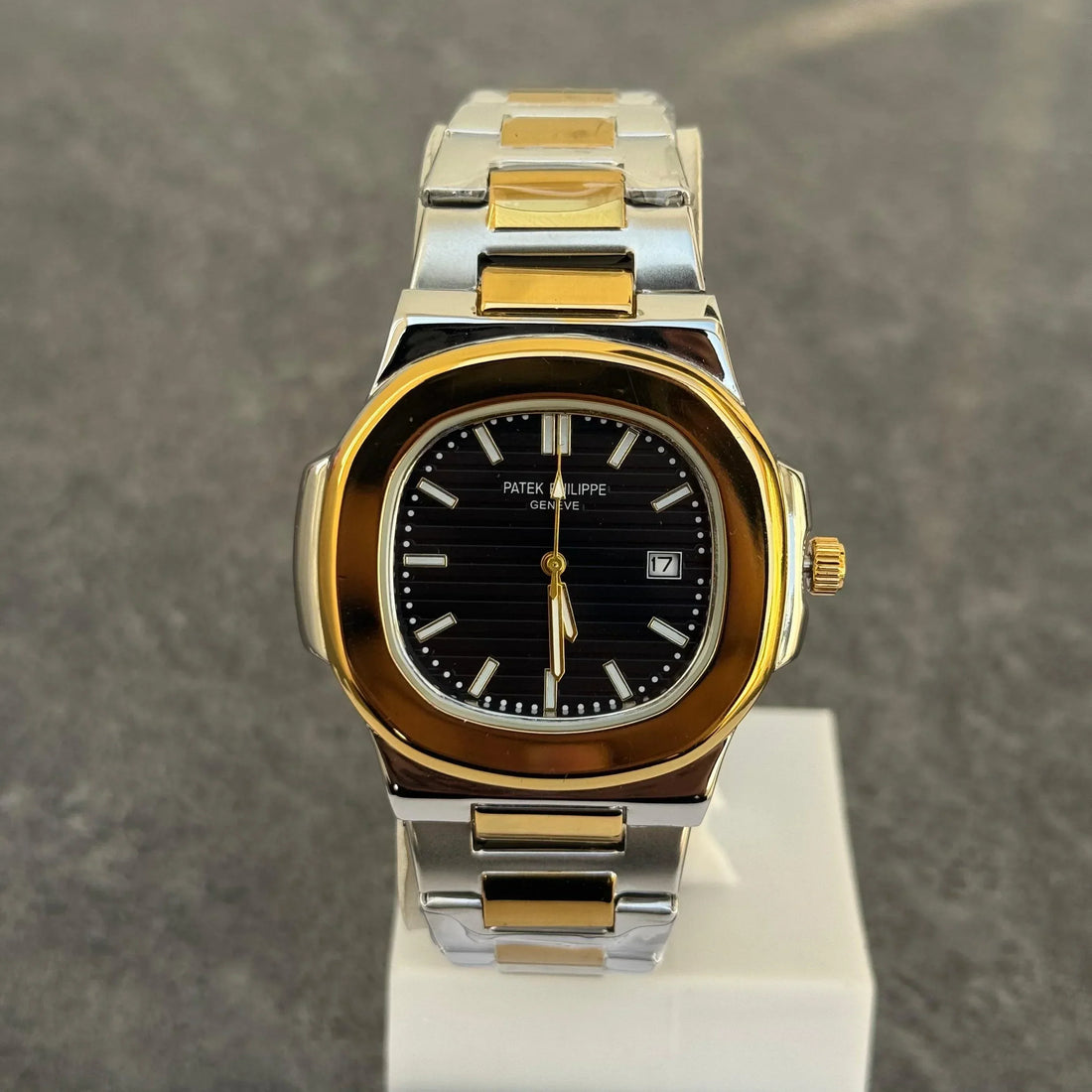 Patek Philippe Two Tone Golden Black Watch with silver and gold metal band held in hand