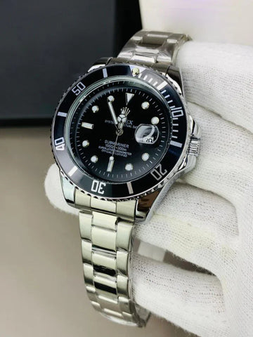 Rolex submariner watch in silver black color with stainless steel band held by a gloved hand