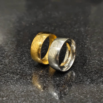 Two classic rings in deal featuring gold and silver bands with textured patterns on a dark surface