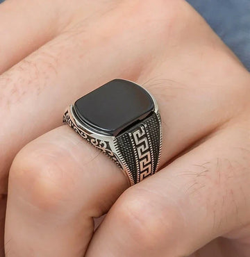 Silver medusa small pattern ring for men with black stone and intricate side engravings on finger