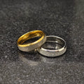 Lamha 2 forever love rings for men with heart engravings in gold and silver finish on dark surface