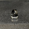 2 rings black and silver for men in pakistan displayed on a dark textured surface by Lamha
