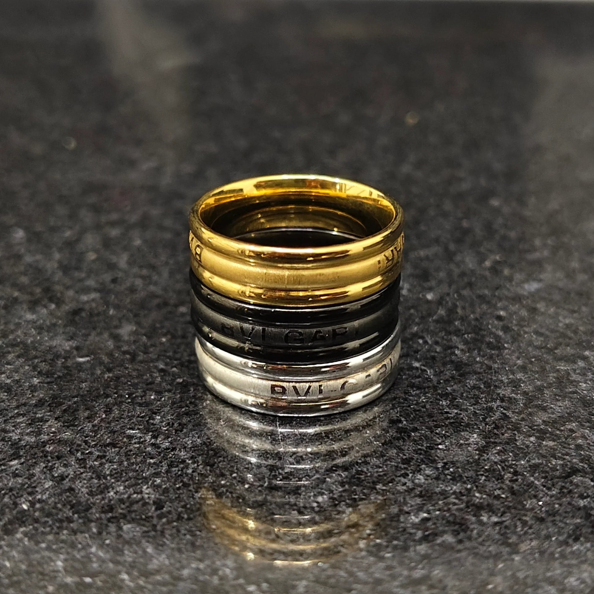 Set of 3 ferrum rings in Pakistan by Lamha featuring gold black and silver metallic finish