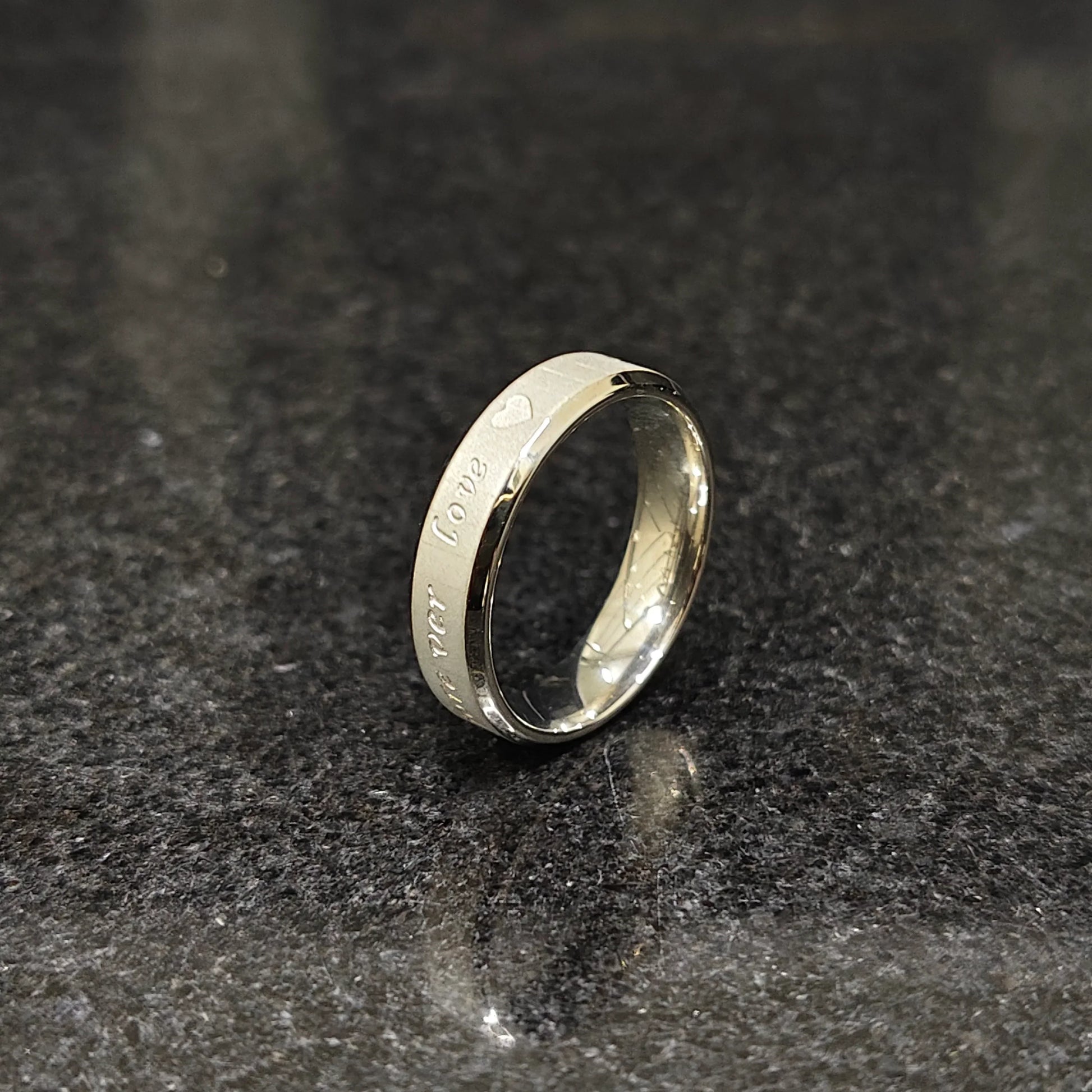 Lamha silver ring with engraved love text on black stone surface best ring for men in silver color