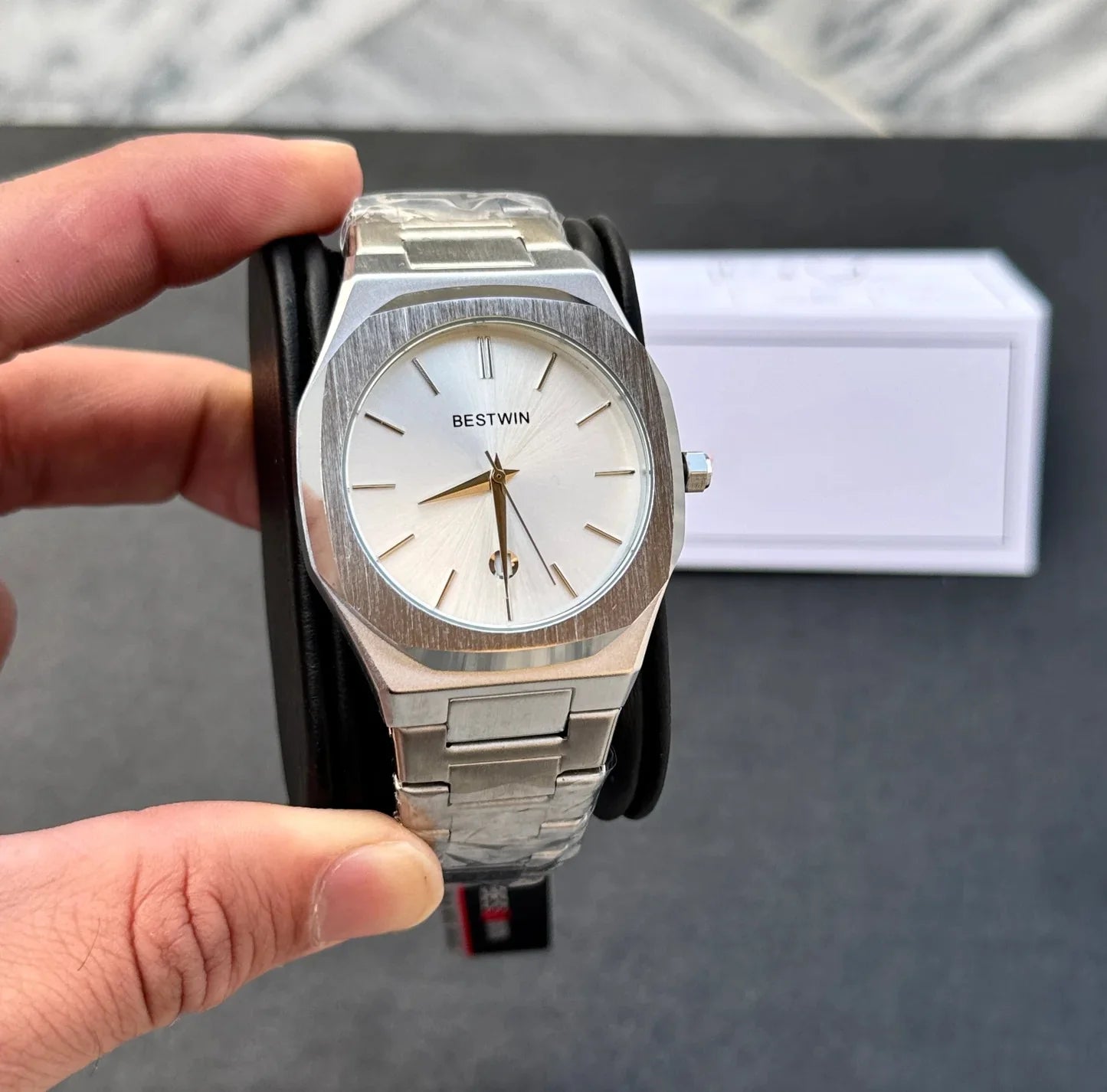 Bestwin Date Just Watch in Silver White held in hand with stainless steel band and minimalistic dial