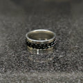 Black Curb Chain ring for men in pakistan by Lamha with silver edges on a dark textured surface
