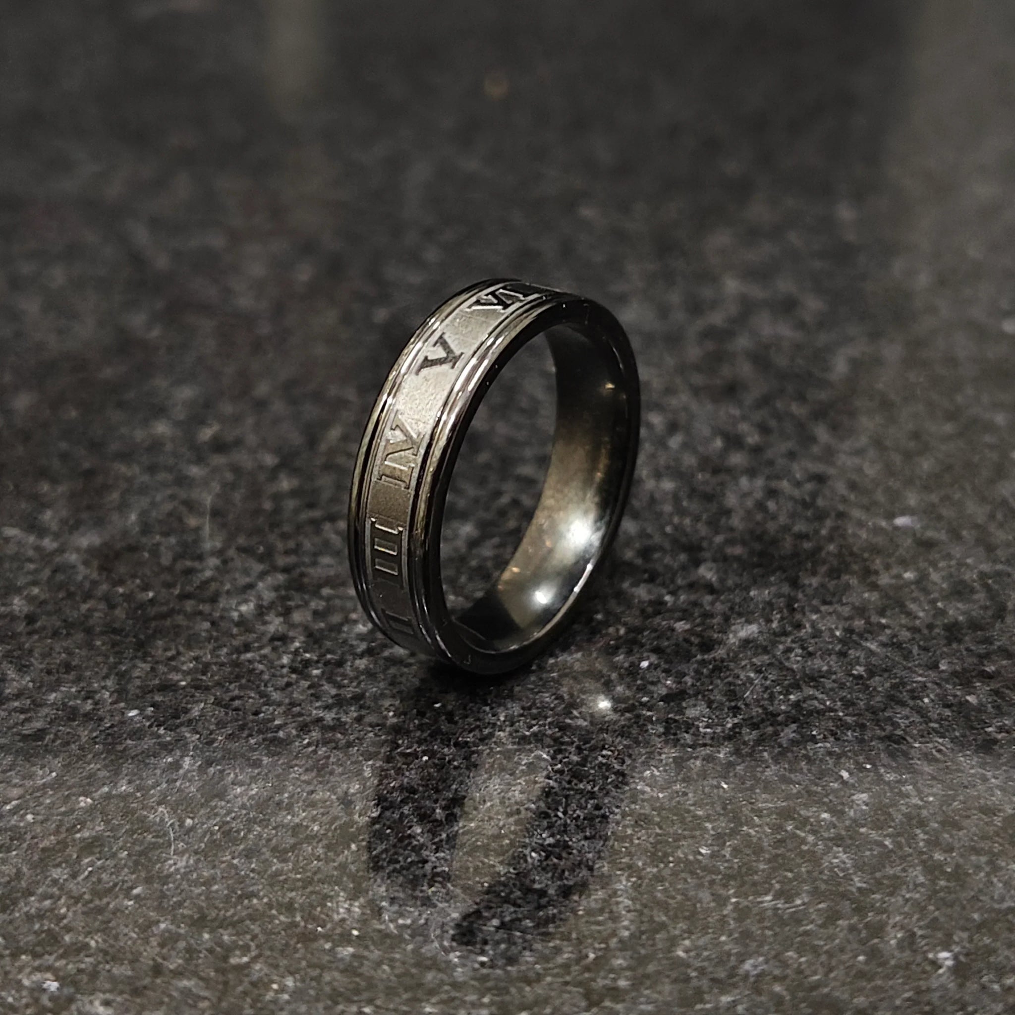 Black roman ring in best design engraved with Roman numerals on a dark textured surface