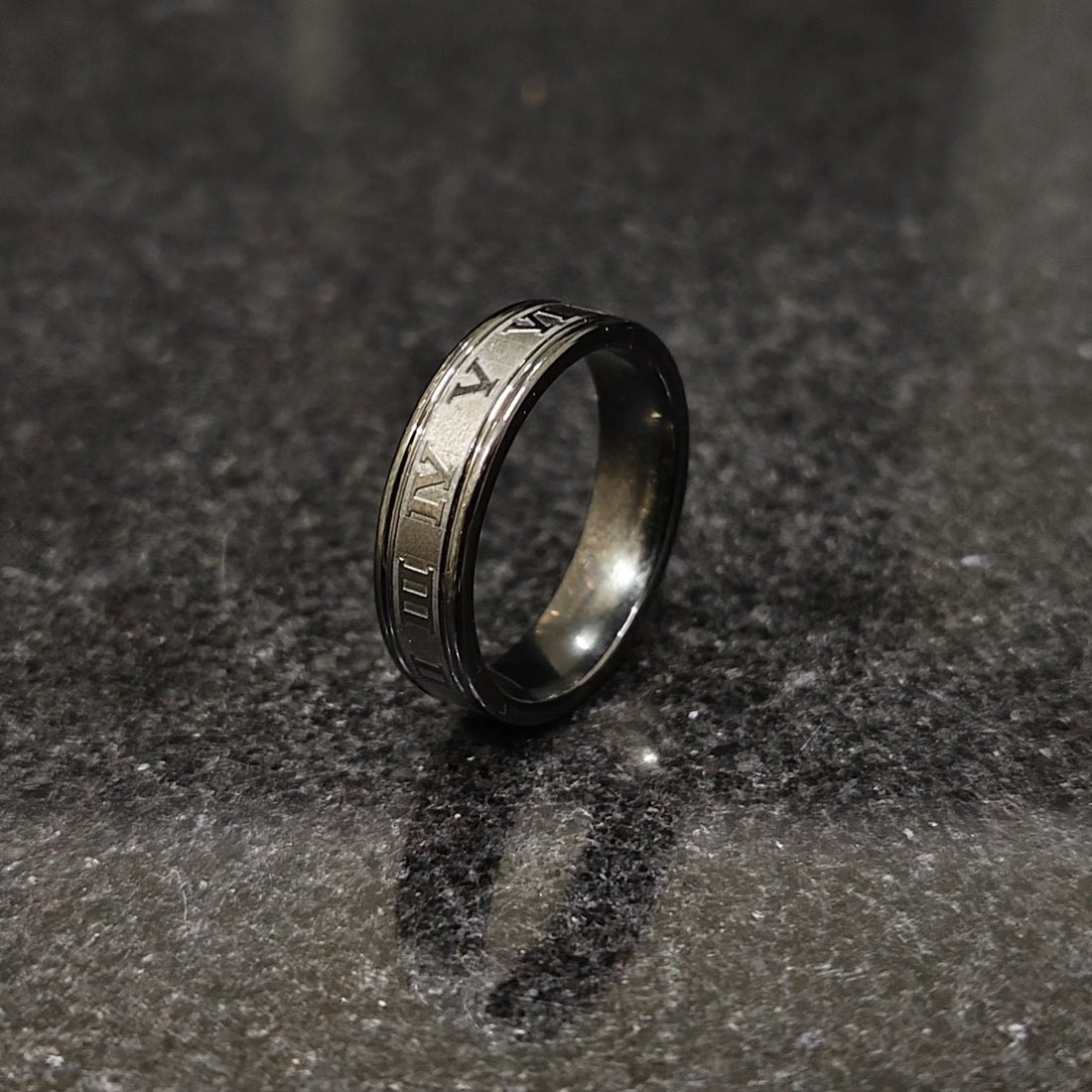 Black roman ring in best design engraved with Roman numerals on a dark textured surface