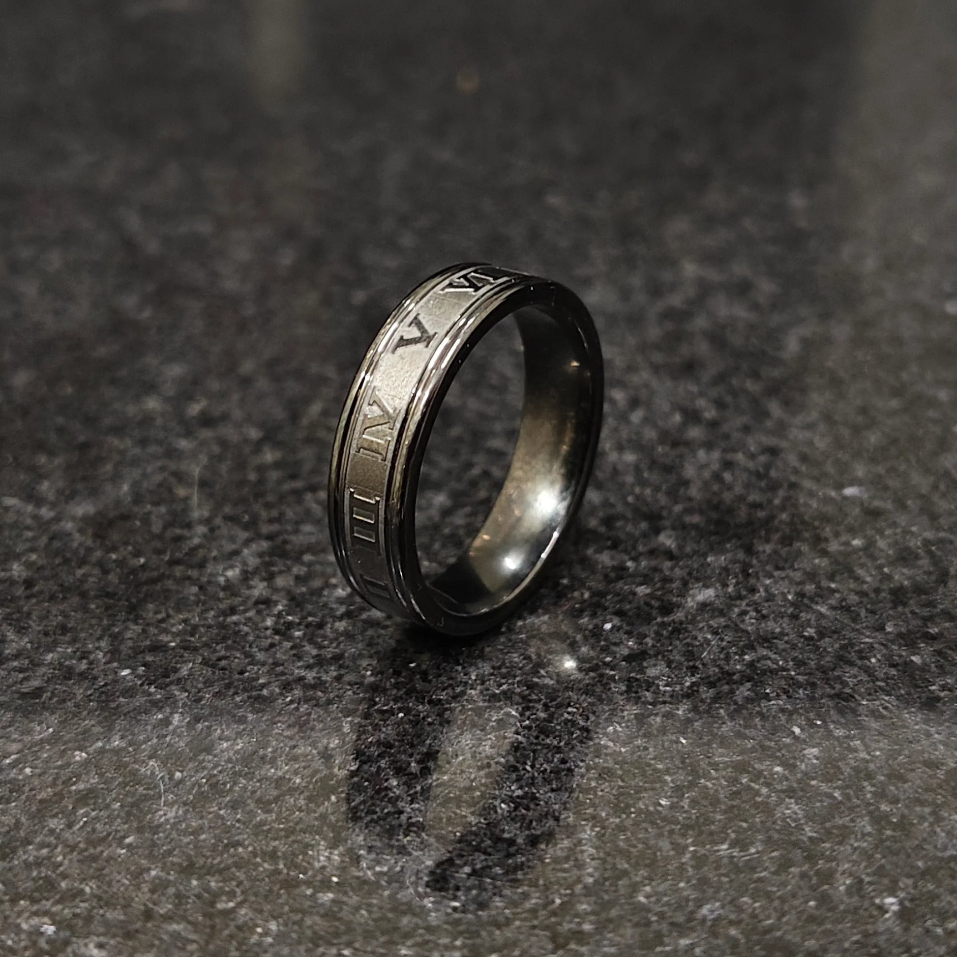 Black roman ring in best design engraved with Roman numerals on a dark textured surface