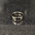 Classic silver ring for men with smooth polished finish by Lamha on black textured surface