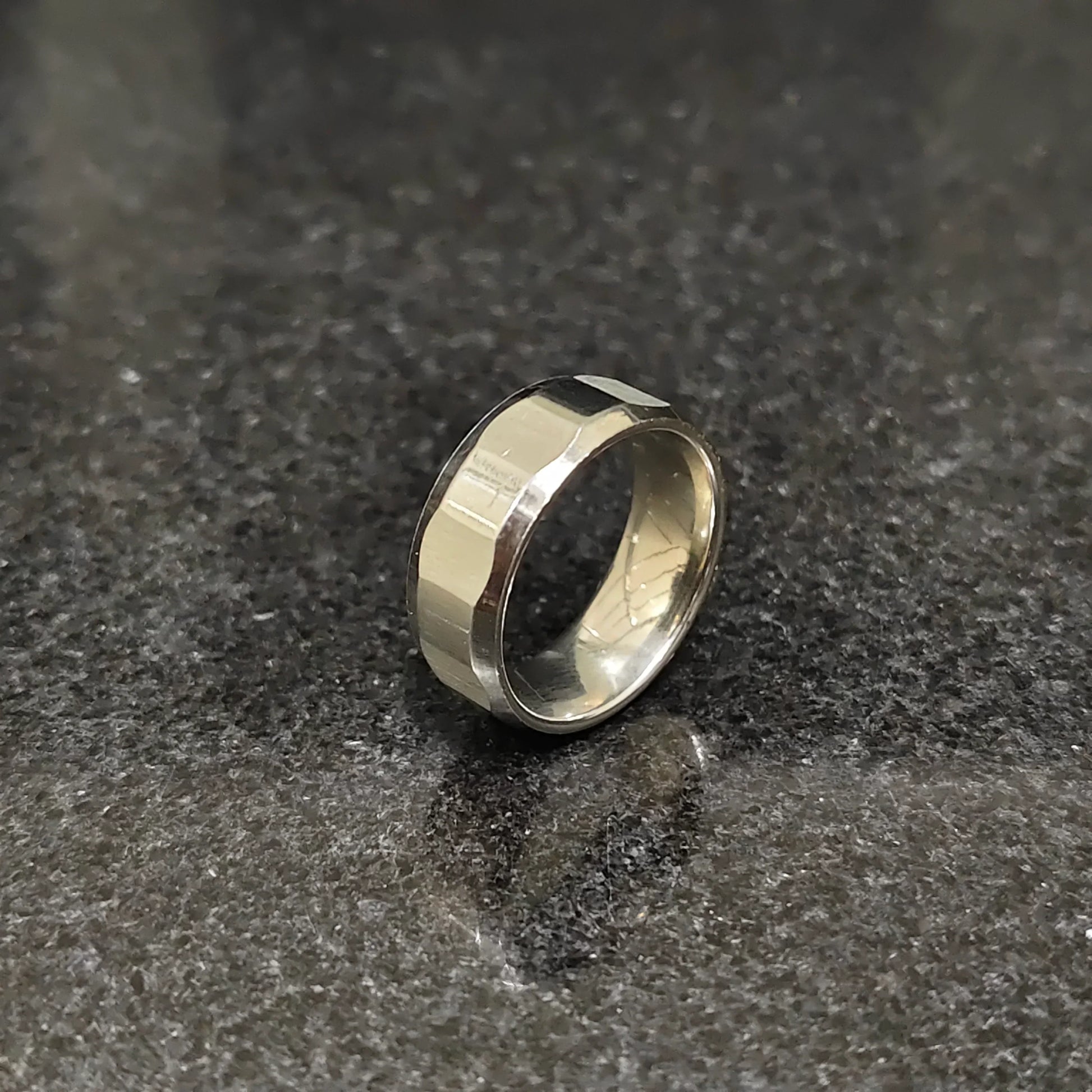 Lamha diamond ring for men in silver color with a polished faceted design on a dark surface