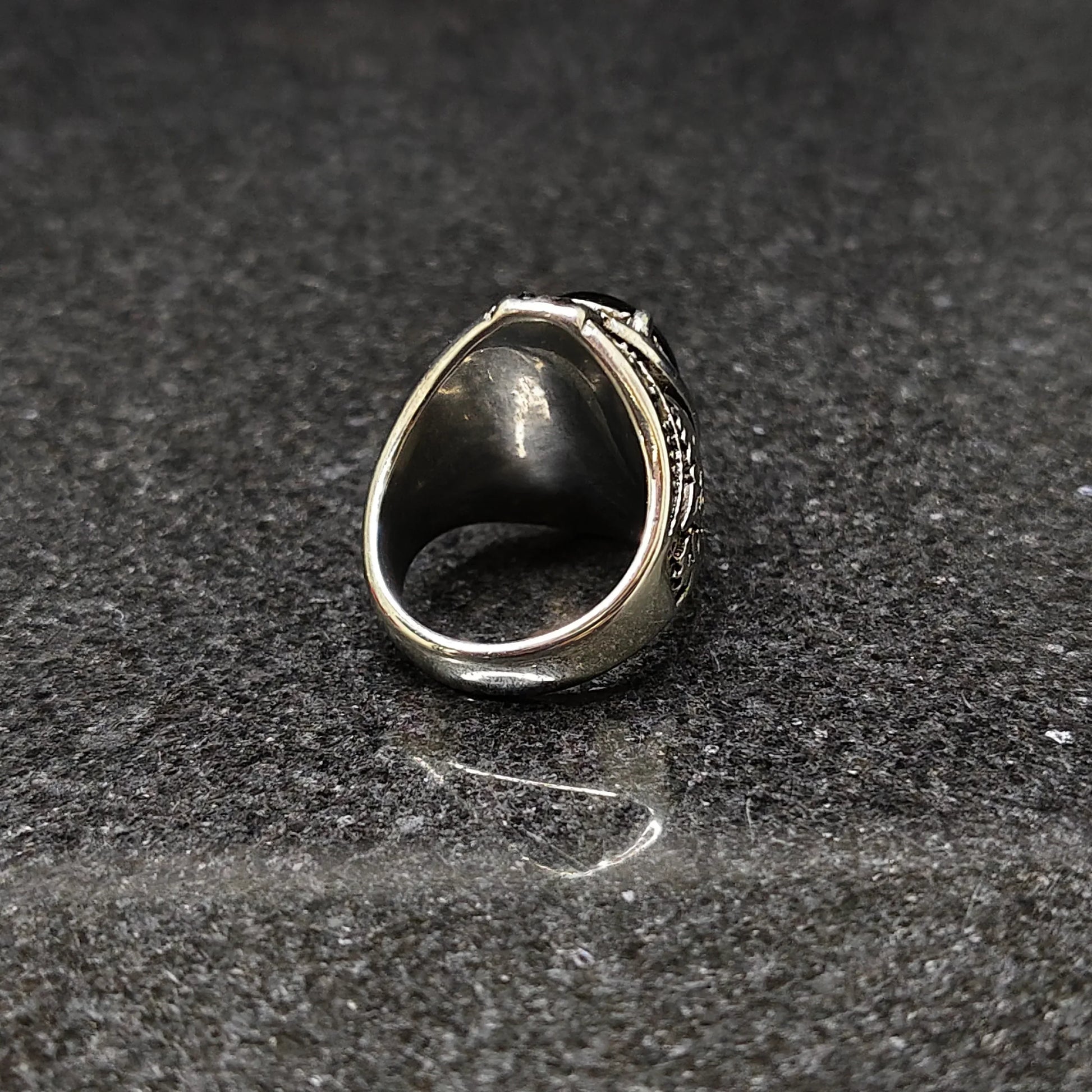 Silver European Ring For Men with intricate design details displayed on dark stone surface