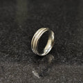 Ferrum ring for men in silver color in pakistan with textured design by Lamha on black surface