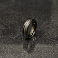 Ferrum ring in black color in pakistan with sleek metallic finish and modern design on dark surface