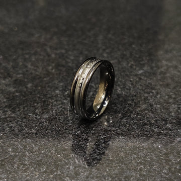Ferrum ring in black color in pakistan with sleek metallic finish and modern design on dark surface