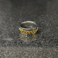 Golden curb chain ring for men in Pakistan with silver base on reflective surface