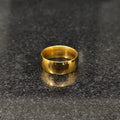 Simple polished golden ring for men in pakistan on dark granite surface by Lamha