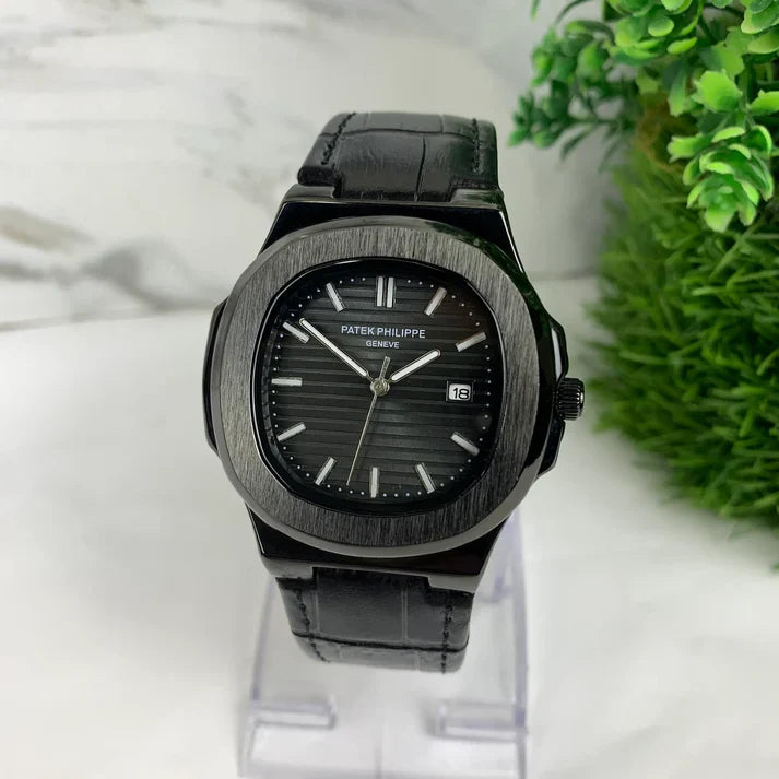 Patek philippe Black strap watch with a black dial and silver hour markers held by a gloved hand