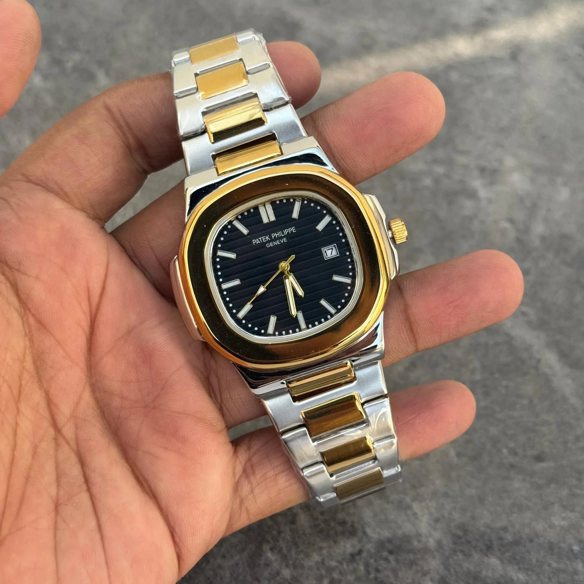 Lamha Patek Philippe Two Tone Golden Black Watch with stainless steel and gold bracelet held in hand
