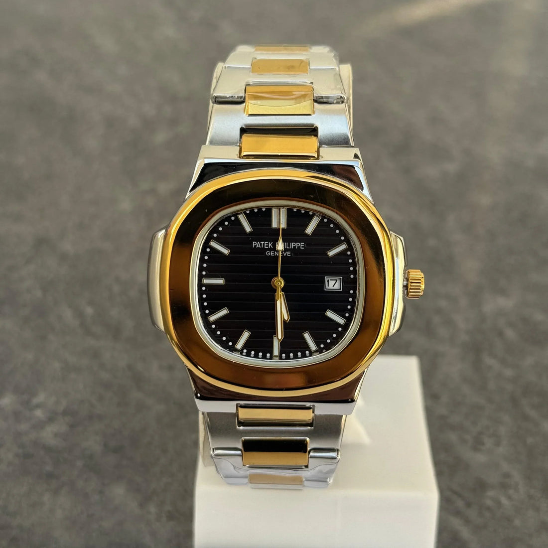 Patek Philippe Two Tone Golden Black Watch with silver and gold metal band held in hand
