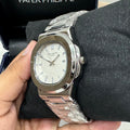 Patek philippe watch in silver white with metal strap and date display on dial