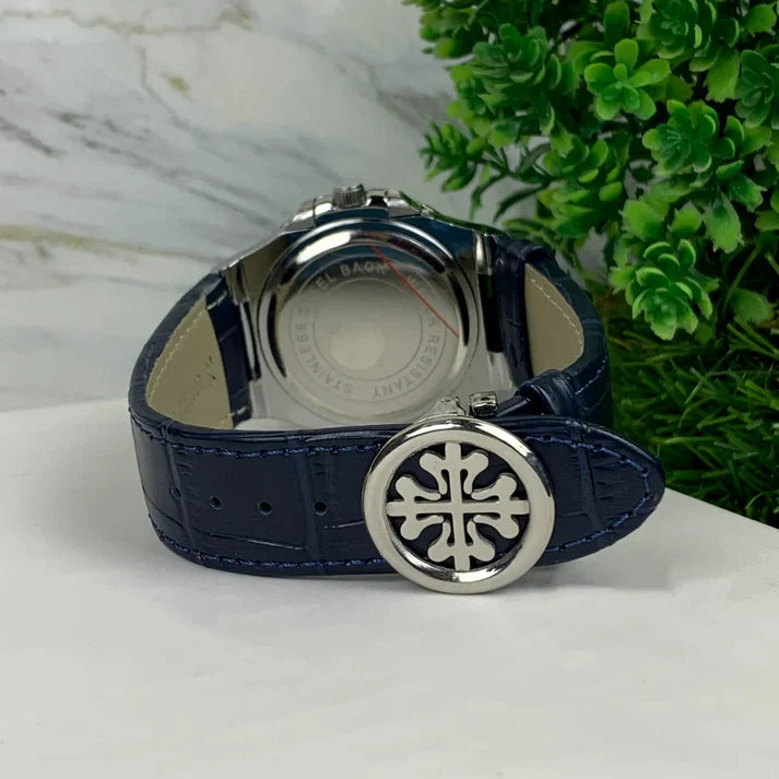Patek Philippe Watch with navy blue leather strap and silver clasp displayed on white surface