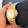 Patek Philippe Watch Two Tone White in Pakistan with gold and silver bracelet and white dial held in hand