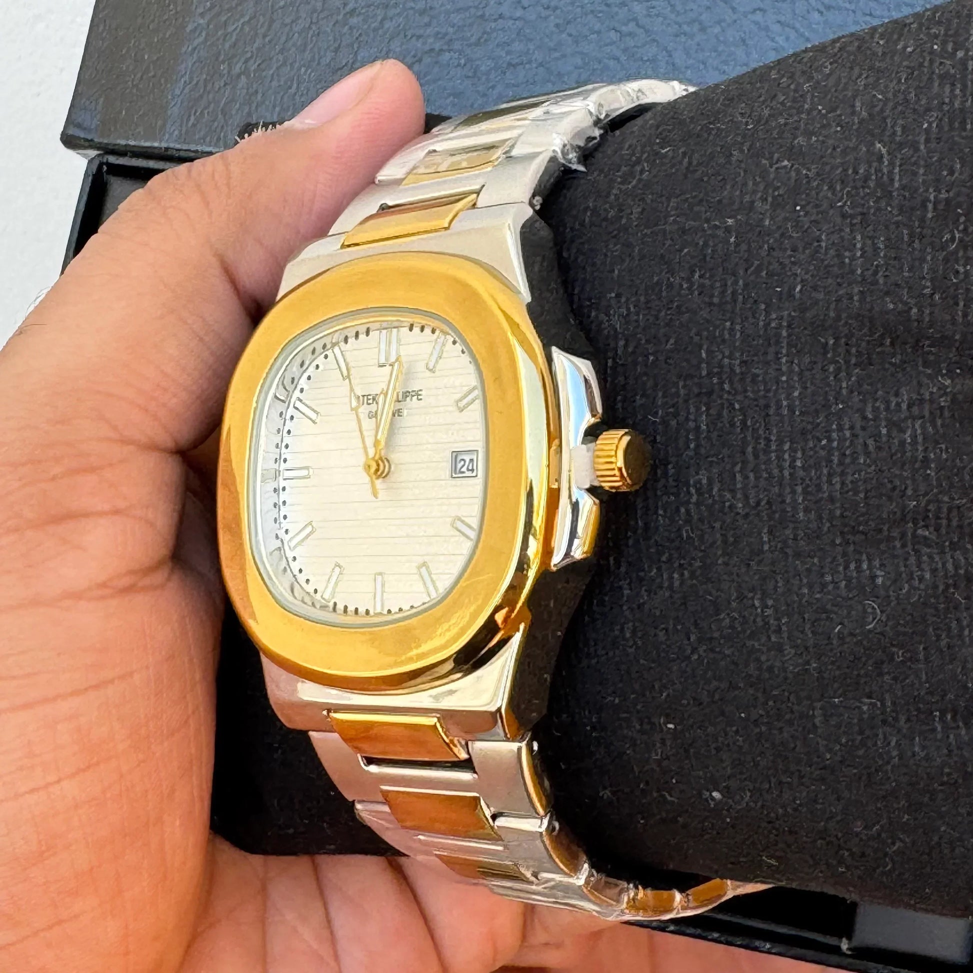Patek Philippe Watch Two Tone White in Pakistan with gold and silver bracelet and white dial held in hand