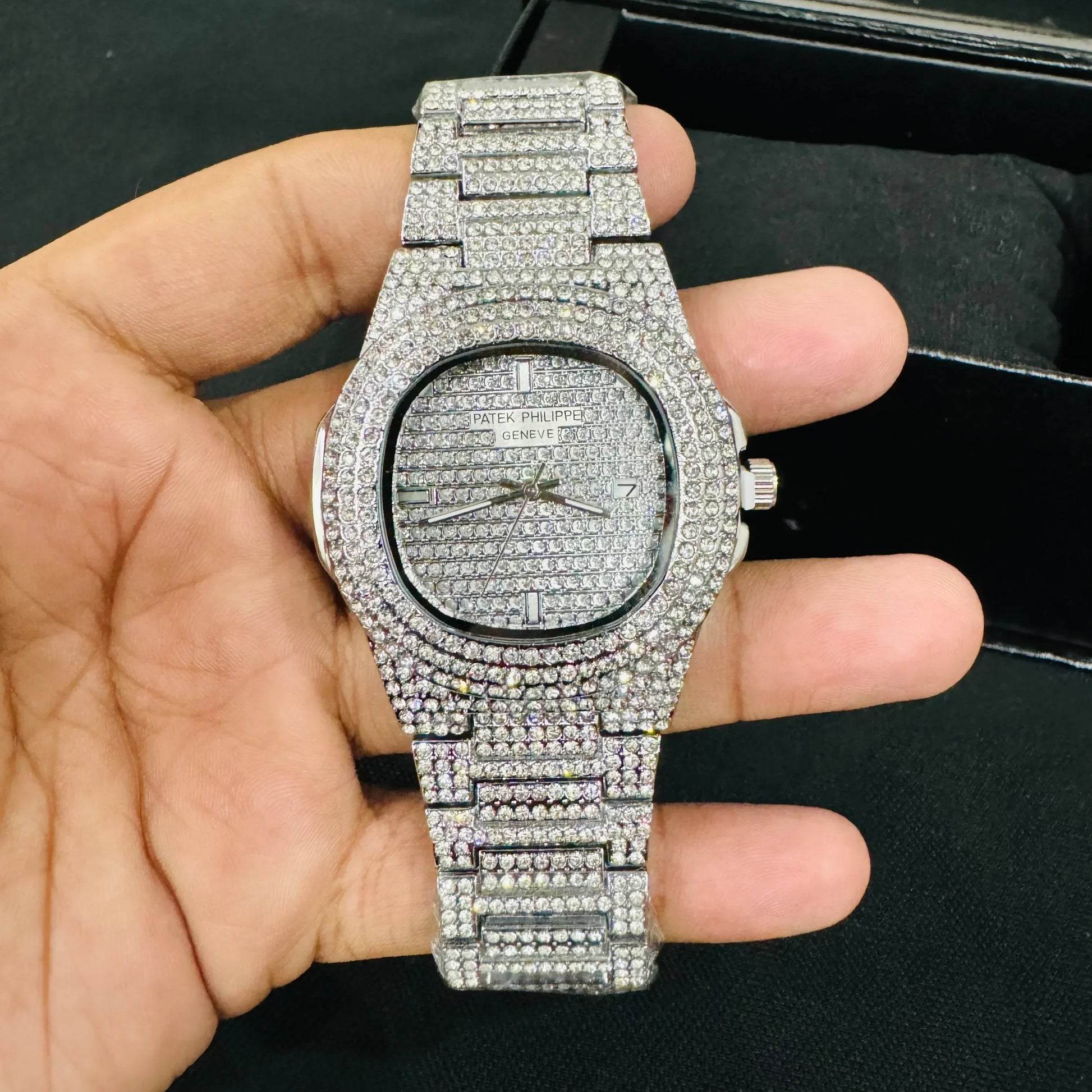 Lamha Patek Philppe Icedout silver watch fully encrusted with diamonds held in hand