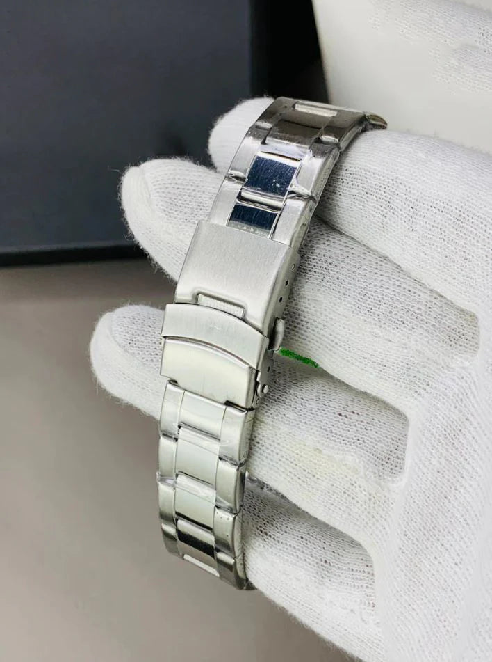 Close-up of a rolex submariner watch in silver black color metal bracelet held by a gloved hand