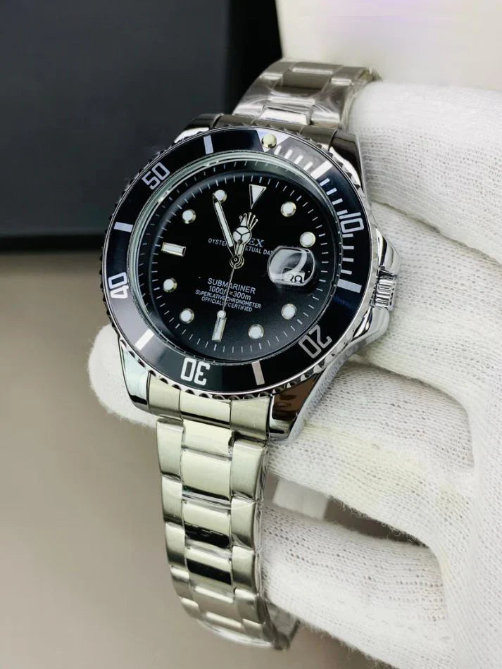 Rolex submariner watch in silver black color with stainless steel band held by a gloved hand
