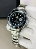 Rolex submariner watch in silver black color with stainless steel band held by a gloved hand