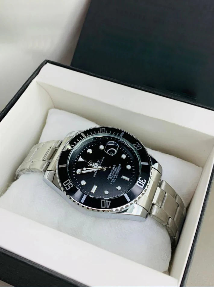 Rolex submariner watch in silver black color with stainless steel band held by a gloved hand
