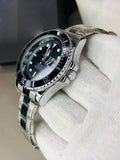 Lamha rolex submariner watch in silver black color with stainless steel band held in white glove