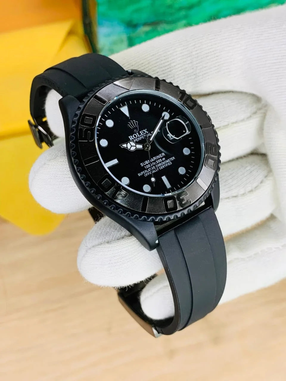 Rolex Yacht Master Date Just full black watch with black rubber strap and silver bezel held by gloved hand