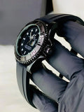 Rolex Yacht Master Date Just Full Black watch with black dial and rubber strap held by gloved hand