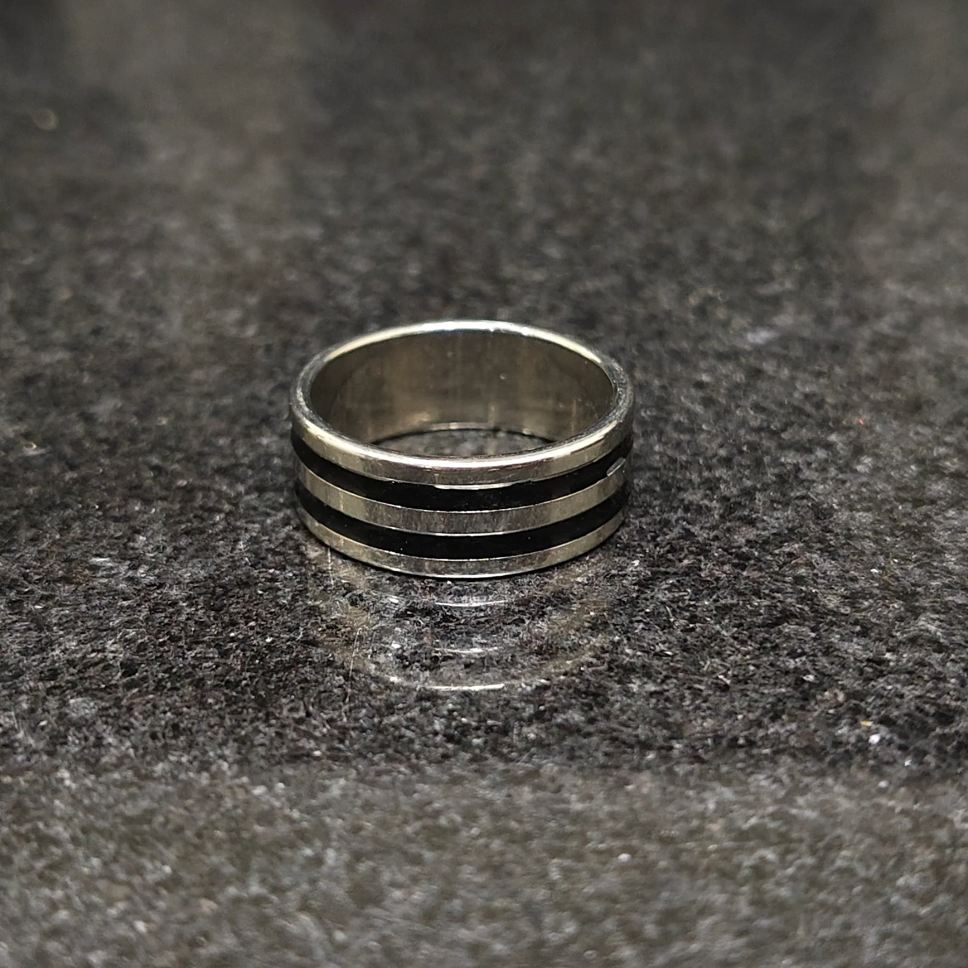 Silver black line ring for men in best design by Lamha on dark textured surface