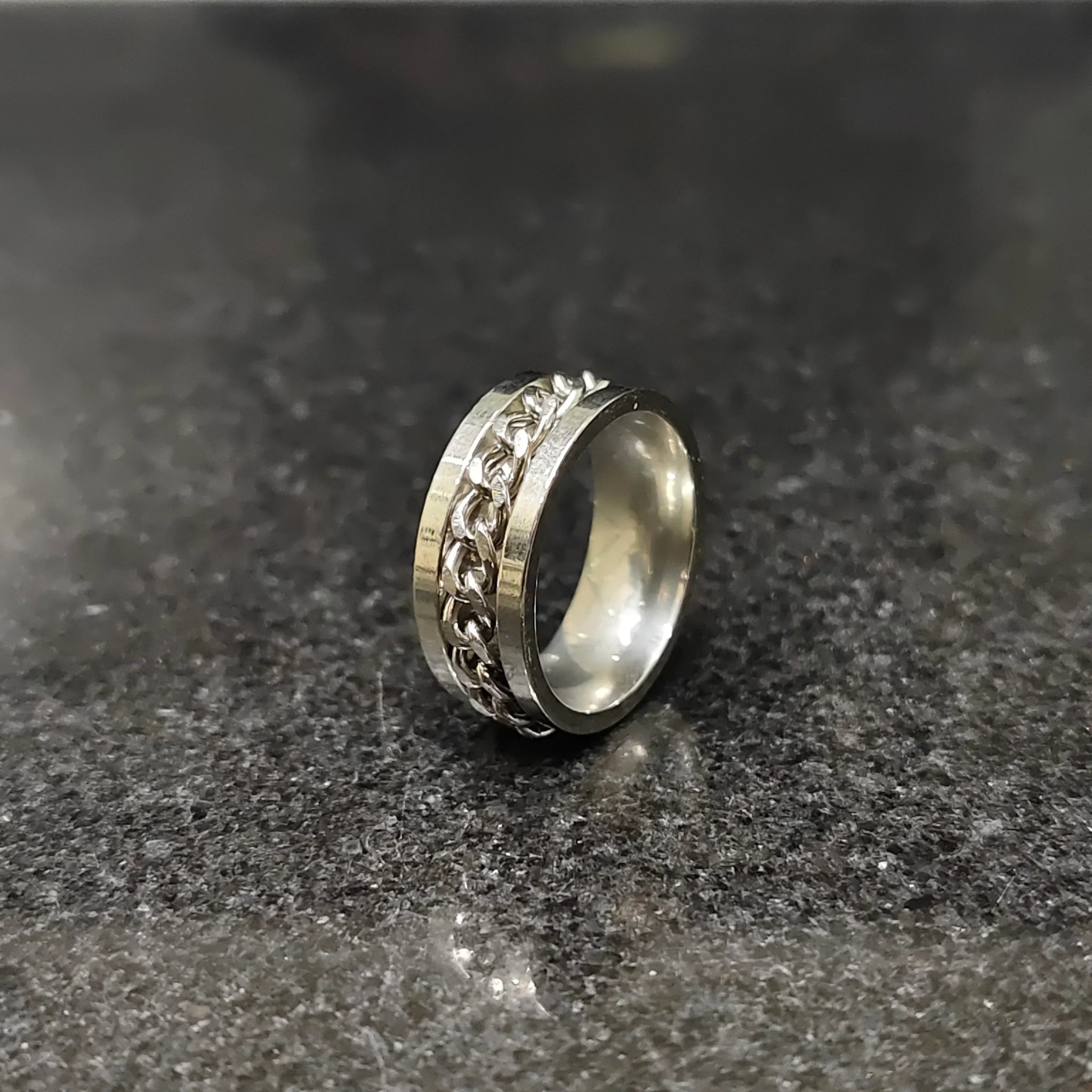 Lamha silver crub chain ring for men in pakistan with a sleek design on a dark surface