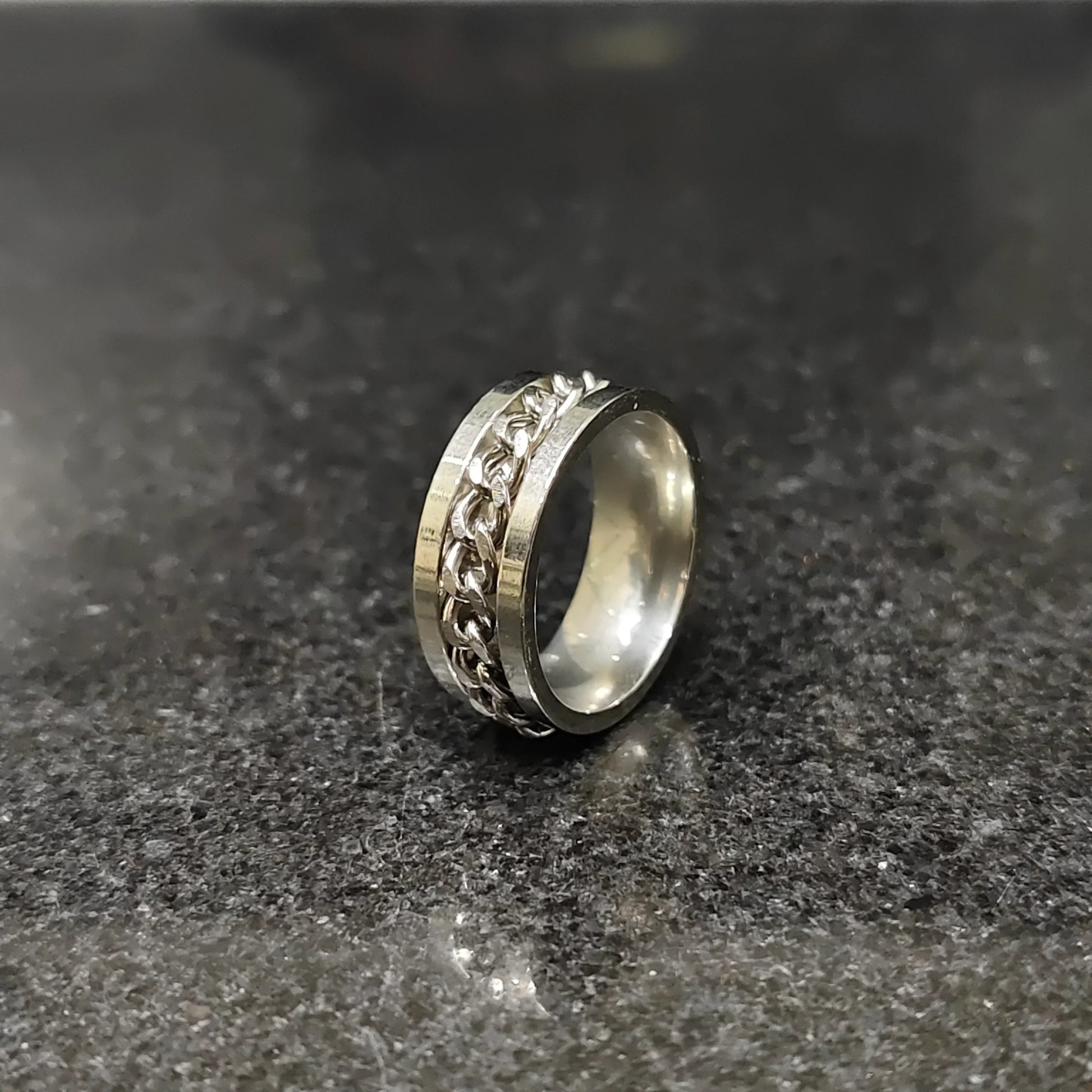 Lamha silver crub chain ring for men in pakistan with a sleek design on a dark surface