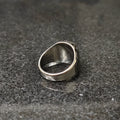 Silver onyx emperor ring for men displayed on black granite surface showcasing smooth inner band and polished silver finish