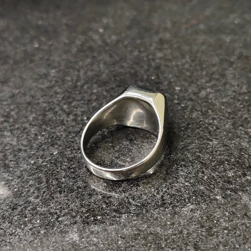 Lamha silver onyx ring for men with a smooth polished finish on a dark textured surface
