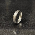Silver roman ring for men in best design in pakistan displayed on dark granite surface