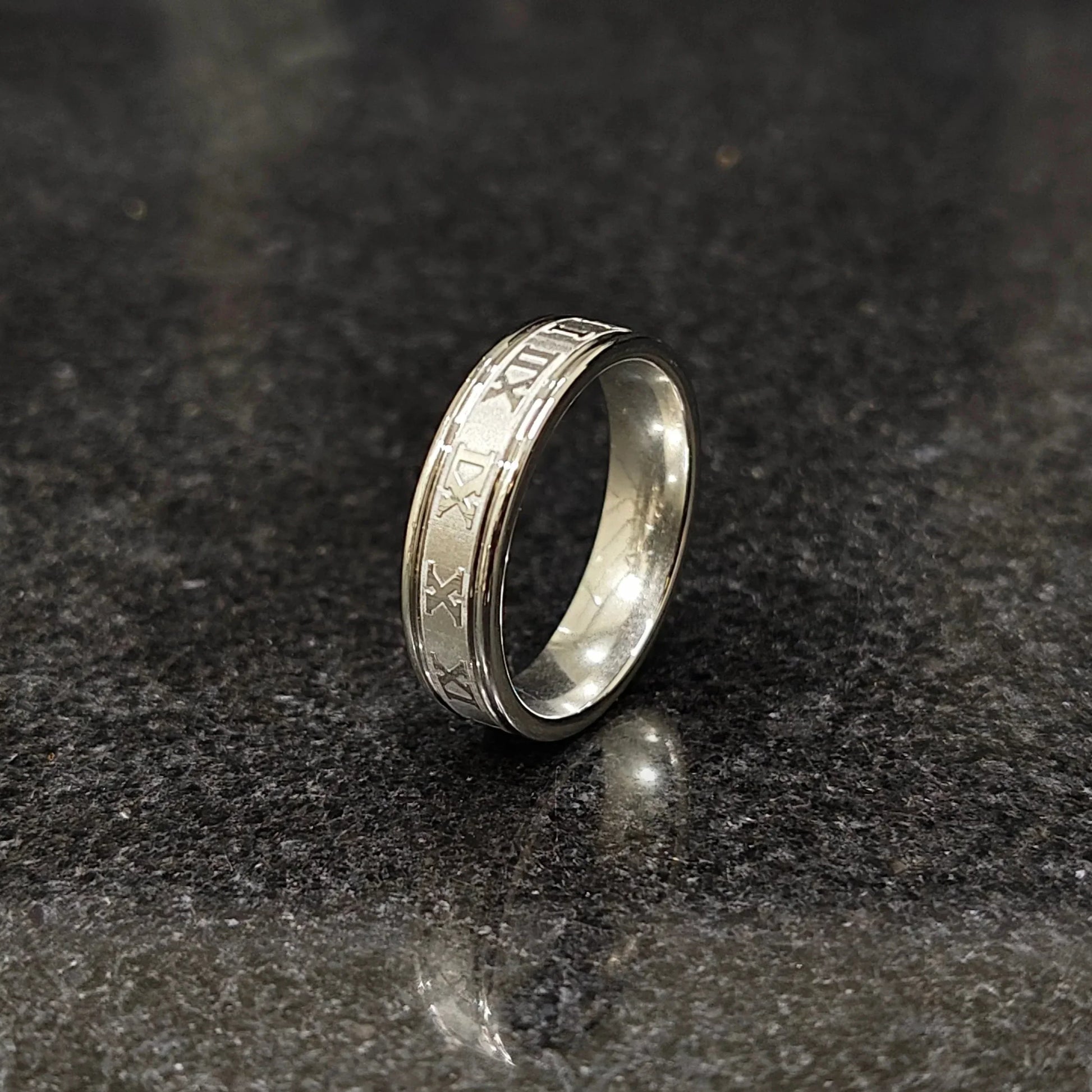 Silver roman ring for men in best design in pakistan displayed on dark granite surface