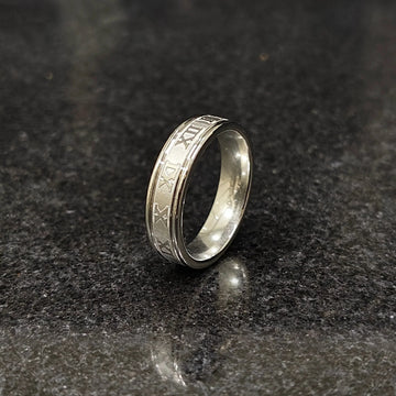 Silver roman ring for men in best design in pakistan displayed on dark granite surface