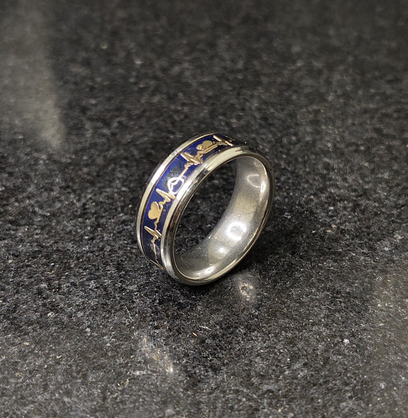 Lamha steal silver ring for men with blue and gold intricate designs on a dark stone surface